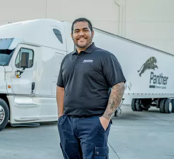 Panther employee standing in front of semi-truck