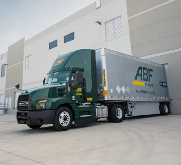 ABF truck in a loading zone at a warehouse.