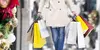 Woman carrying holiday shopping bags.