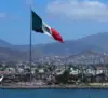 Mexico’s flag flying on the shoreline between the U.S. and Mexico